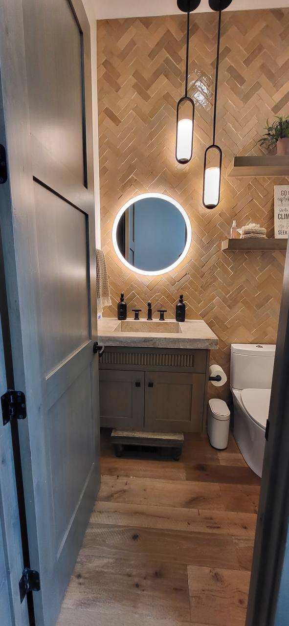 Herringbone powder room with backlit mirror
